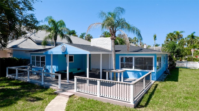 rear view of house with an outdoor living space, a yard, and a patio