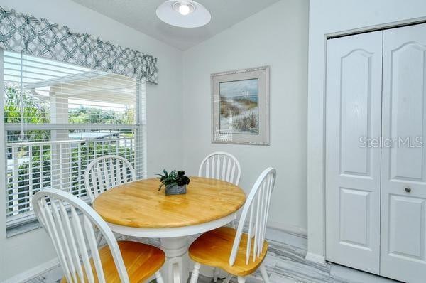 dining space featuring light hardwood / wood-style floors and vaulted ceiling