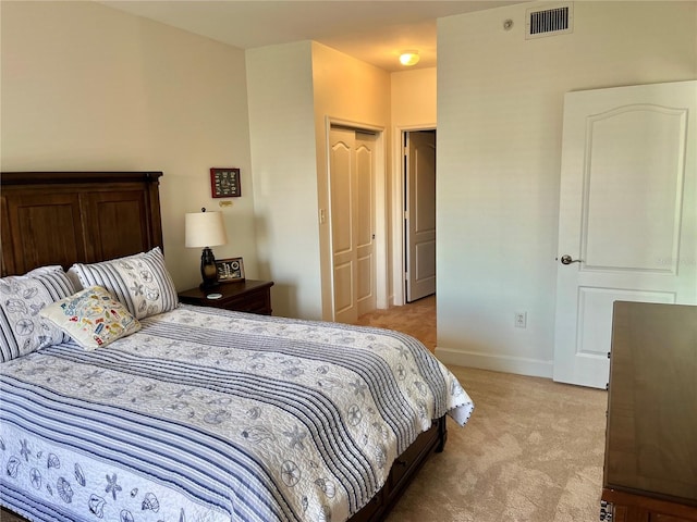 bedroom featuring a closet and light colored carpet