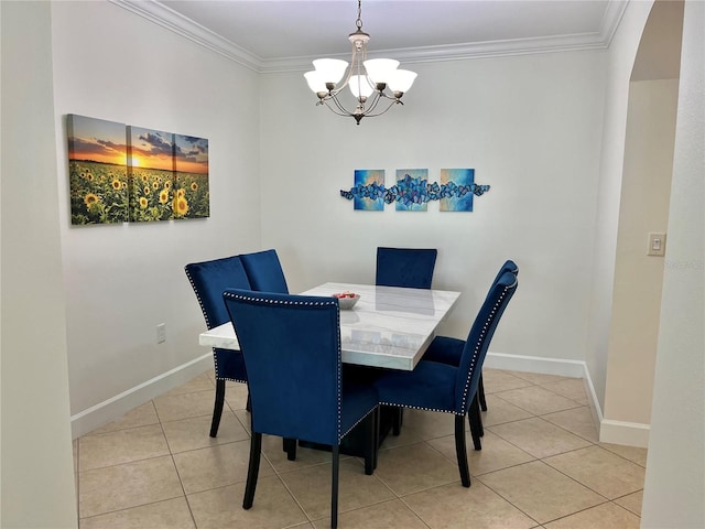 tiled dining area featuring crown molding and an inviting chandelier