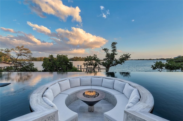 exterior space featuring a fire pit and a water view