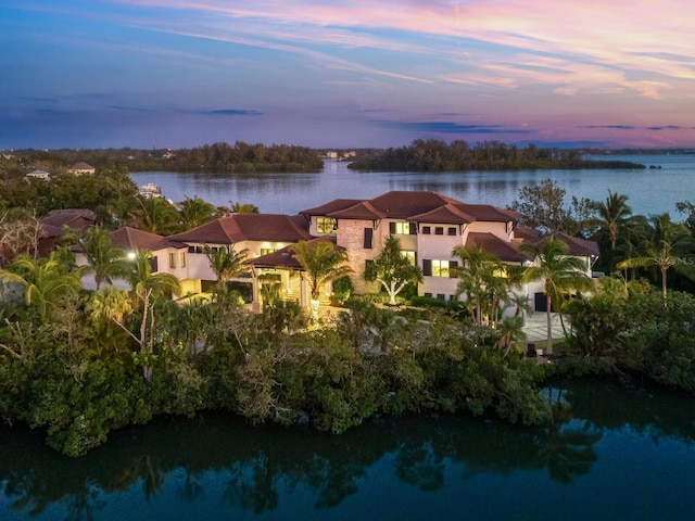 aerial view at dusk with a water view