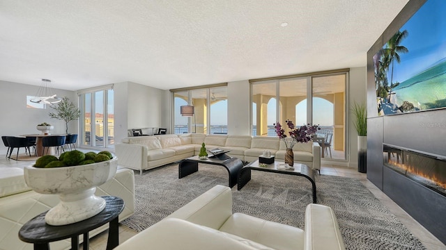 tiled living room featuring a textured ceiling and expansive windows