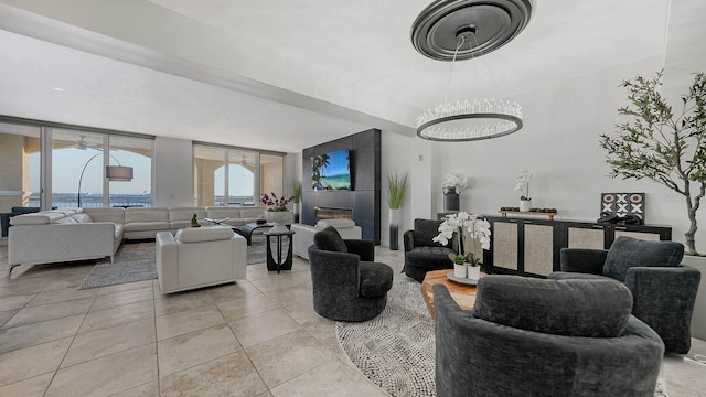 living area with a glass covered fireplace, floor to ceiling windows, and light tile patterned floors