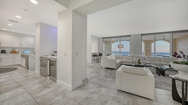 living room featuring recessed lighting, visible vents, wine cooler, and baseboards