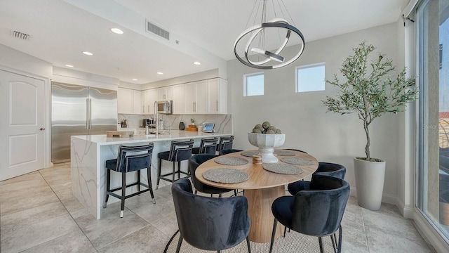 dining area with recessed lighting, visible vents, and baseboards