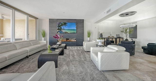 tiled living room featuring visible vents, a fireplace, and a textured ceiling