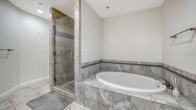 bathroom with recessed lighting, a shower stall, tile patterned flooring, baseboards, and a bath