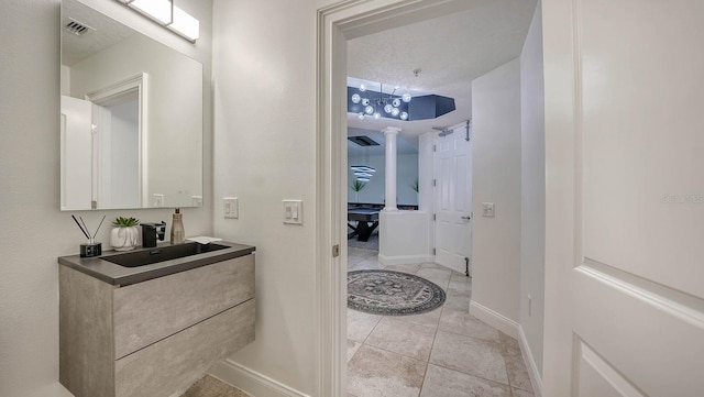 bathroom with vanity, tile patterned floors, and a textured ceiling