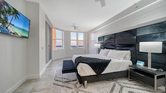 bedroom featuring tile patterned flooring, a ceiling fan, and baseboards