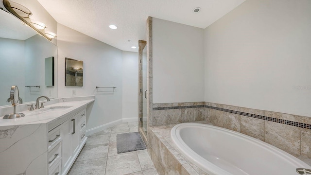 bathroom with vanity, a relaxing tiled tub, and tile patterned floors