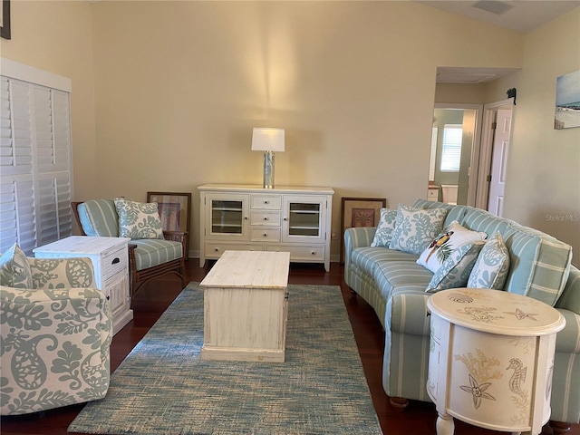 living room with vaulted ceiling and dark wood-type flooring