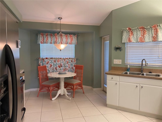 dining space with sink and light tile floors