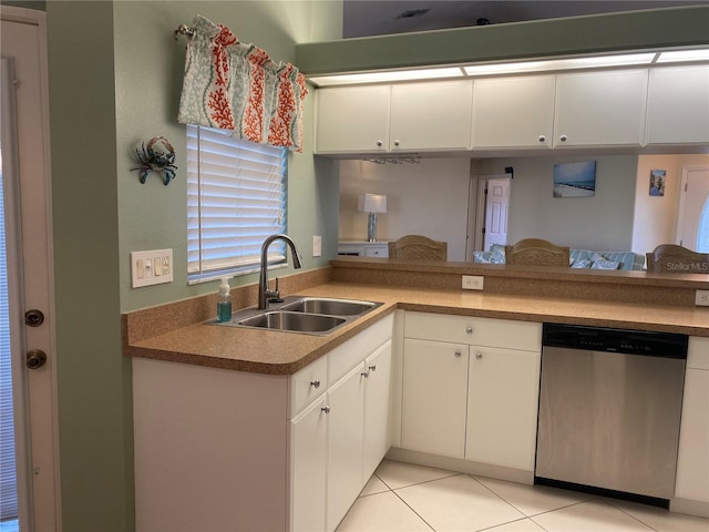 kitchen with kitchen peninsula, sink, white cabinets, stainless steel dishwasher, and light tile flooring