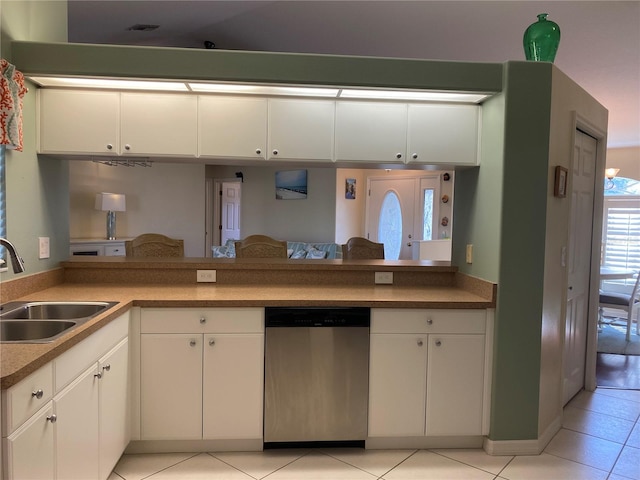 kitchen with sink, white cabinetry, light tile floors, and dishwasher