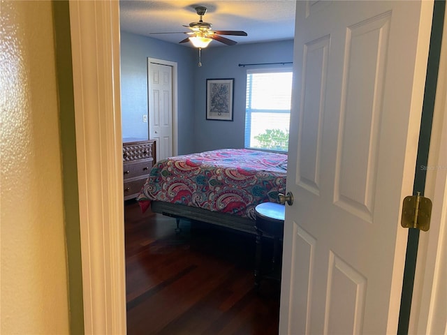 bedroom with ceiling fan and dark hardwood / wood-style floors