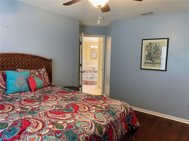 bedroom featuring ceiling fan, ensuite bathroom, and light wood-type flooring