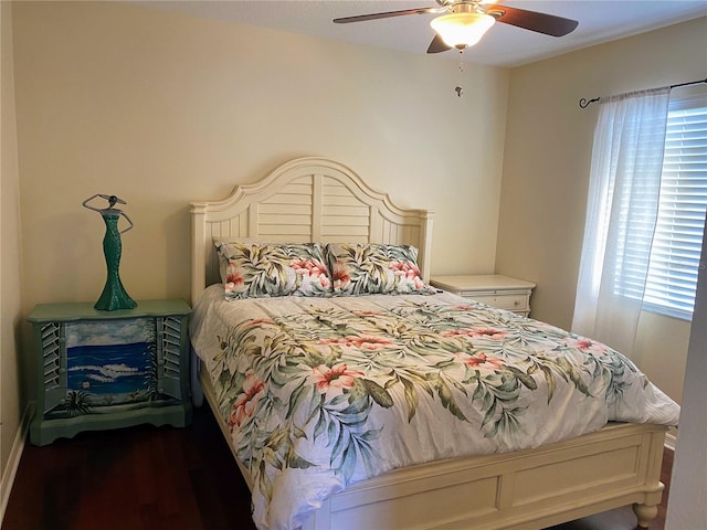 bedroom with ceiling fan and dark hardwood / wood-style floors