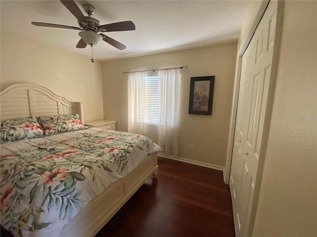 bedroom with a closet, dark hardwood / wood-style floors, and ceiling fan