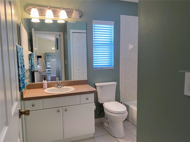 full bathroom featuring tiled shower / bath combo, toilet, vanity, and tile flooring