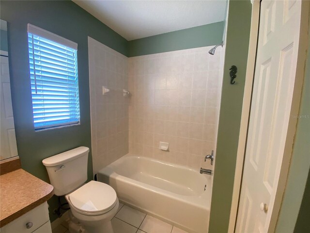 full bathroom with tile floors, toilet, vanity, and tiled shower / bath