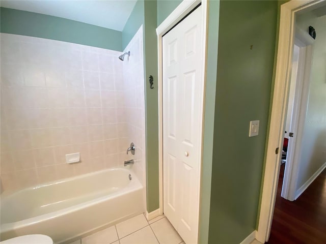 bathroom with shower / bathtub combination, toilet, and wood-type flooring