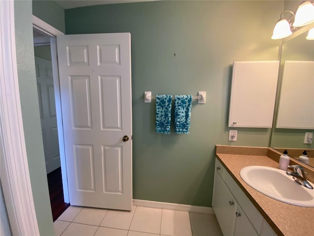 bathroom with an inviting chandelier, tile floors, and vanity