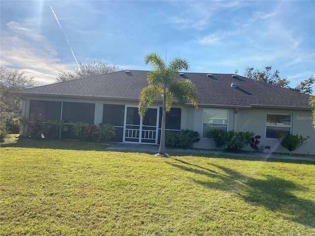 back of property featuring a lawn