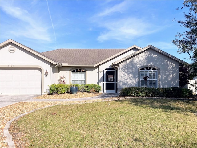 ranch-style house featuring a front yard and a garage