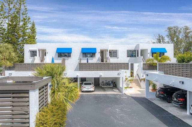 exterior space with a balcony and a carport