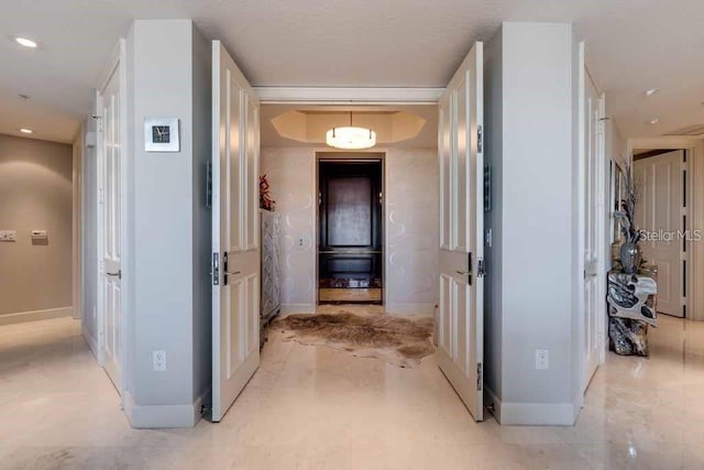 hall with light tile flooring