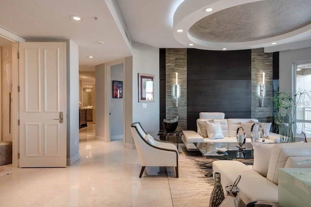 living room featuring a tray ceiling and light tile flooring