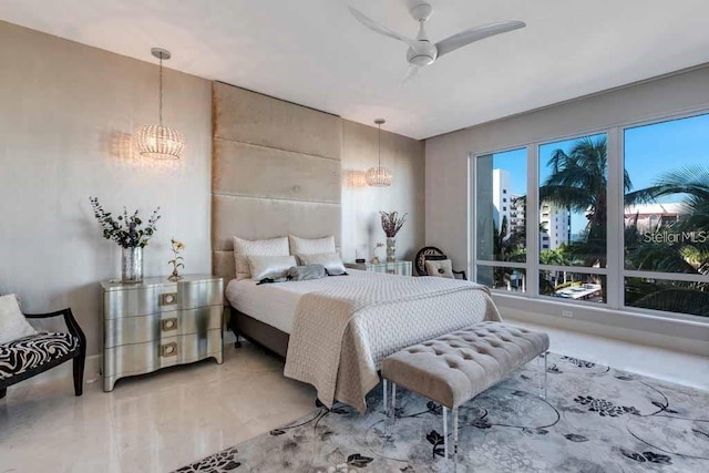 bedroom featuring ceiling fan with notable chandelier