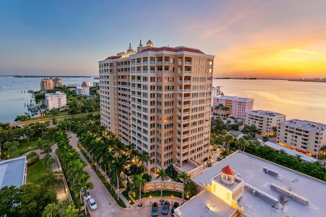 view of building exterior with a water view and a city view