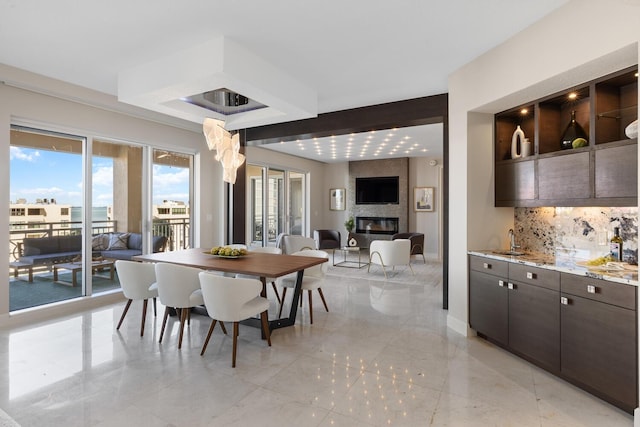 dining area with baseboards and a fireplace