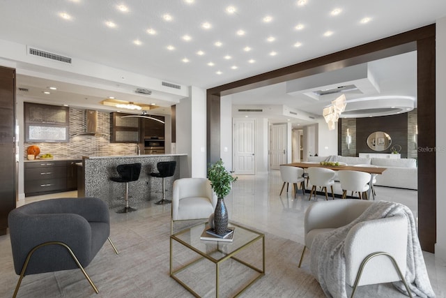 living area with beam ceiling, recessed lighting, and visible vents