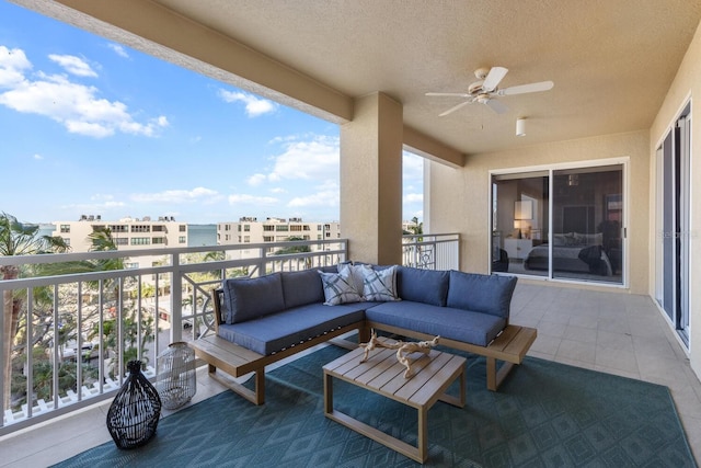 balcony with an outdoor living space and a ceiling fan