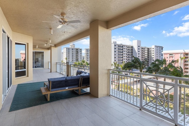 balcony with a view of city and a ceiling fan