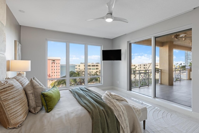 tiled bedroom featuring baseboards, access to exterior, and a ceiling fan