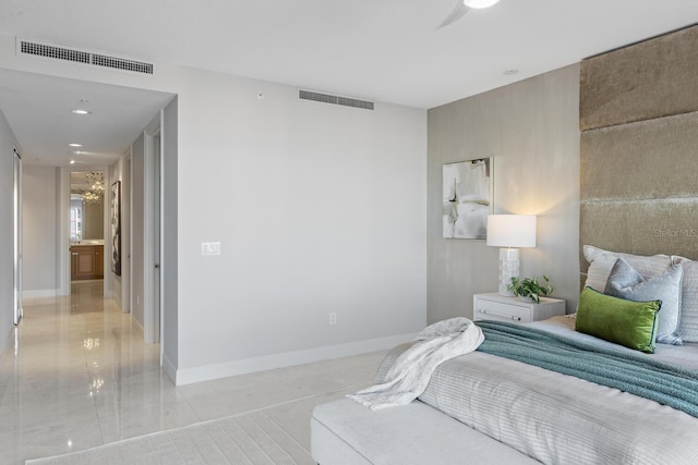 bedroom featuring baseboards and visible vents