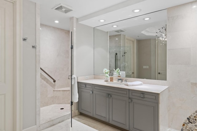 full bath featuring vanity, visible vents, recessed lighting, a stall shower, and tile walls