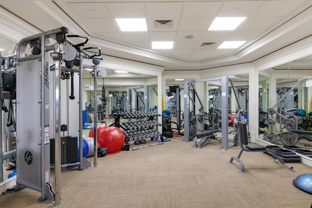 workout area with visible vents, carpet flooring, and ornamental molding