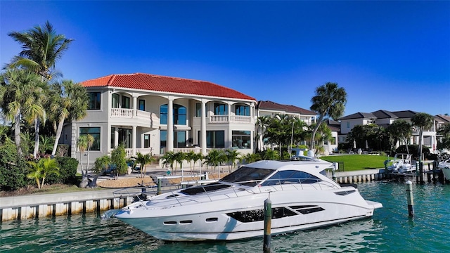 rear view of house with a balcony and a water view