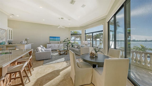 dining area with ornamental molding and ceiling fan