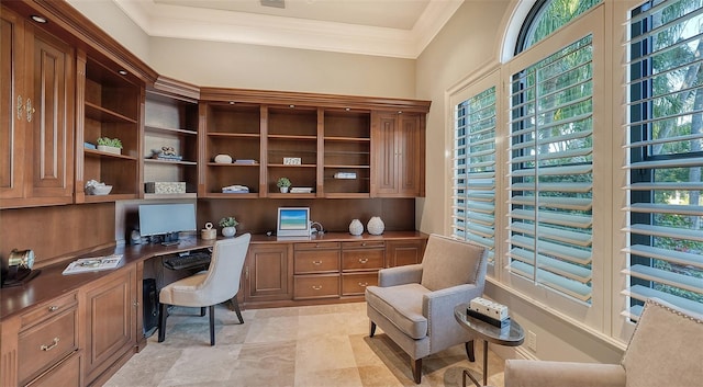 office area with built in desk, plenty of natural light, and crown molding