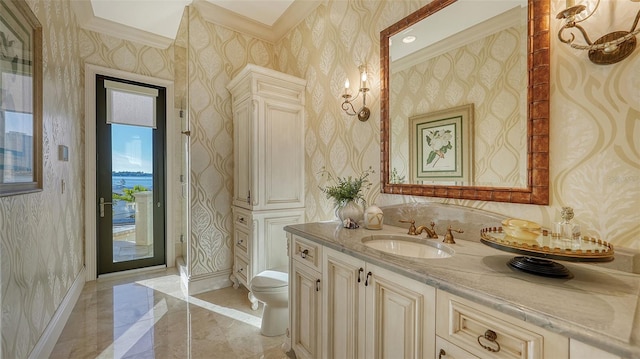 bathroom with crown molding, vanity, and toilet