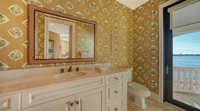 bathroom featuring crown molding, a water view, vanity, and toilet