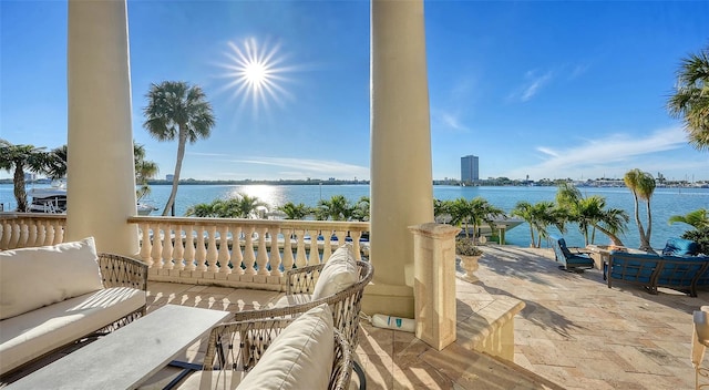 exterior space with a water view and an outdoor living space