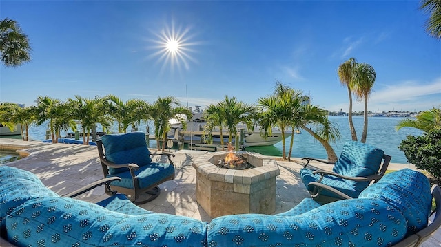 view of patio / terrace with a water view and a fire pit