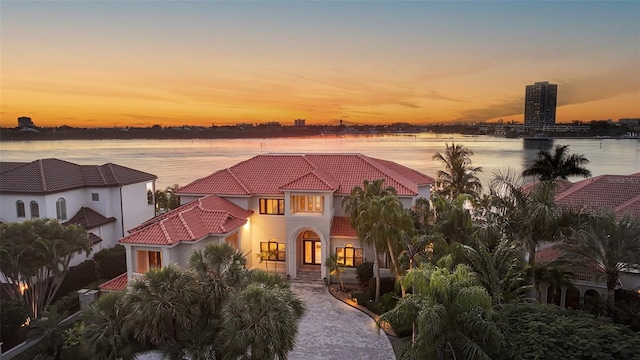 mediterranean / spanish home with a water view